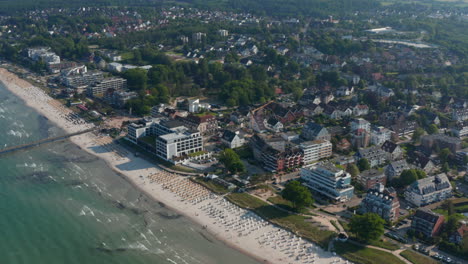 Beautiful-high-aerial-drone-view-of-tourist-baltic-sea-beach-in-Scharbeutz,-Germany,-forward,-day